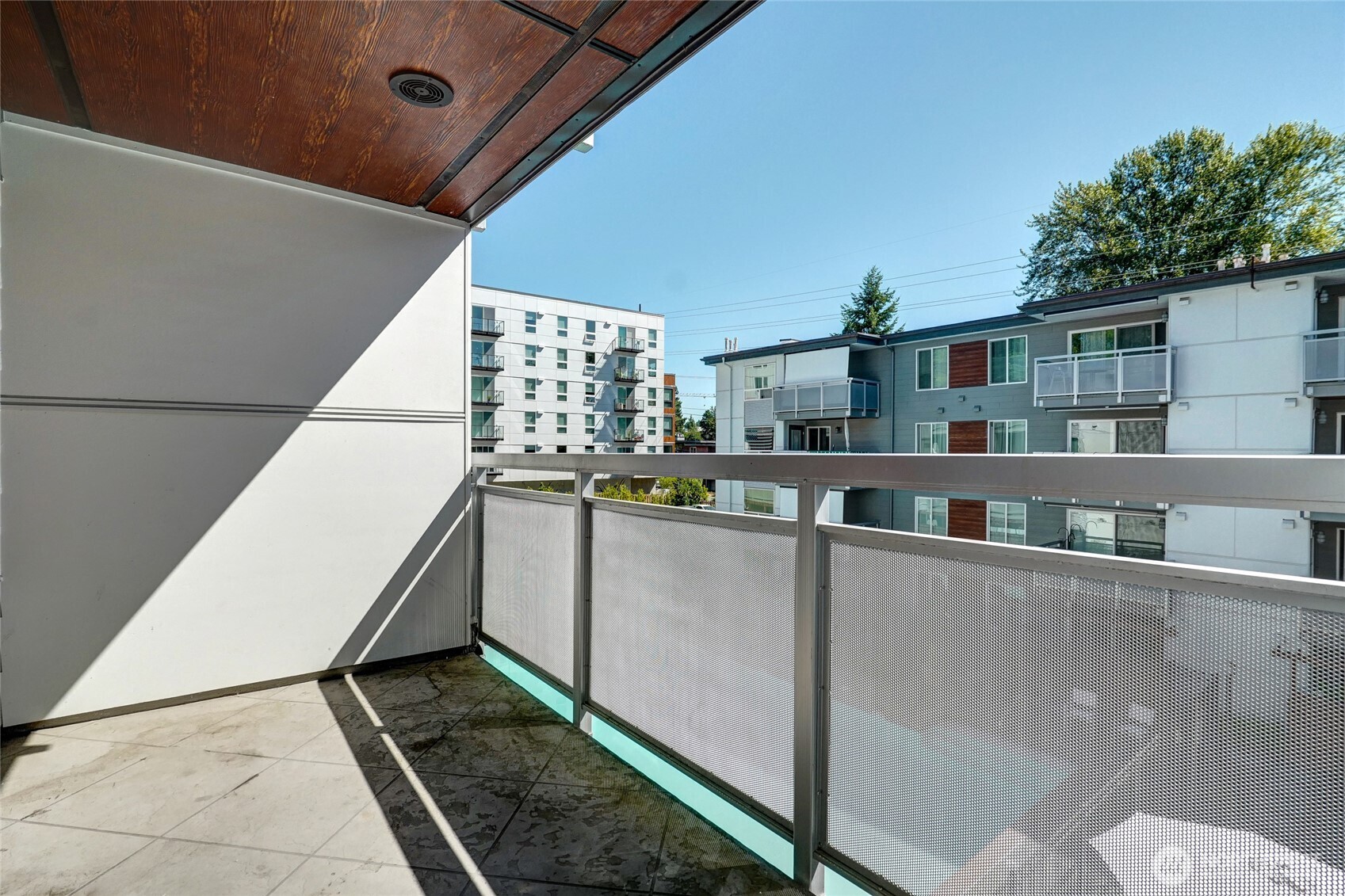 10501 8th Avenue Northeast, Unit 334 Seattle, WA 98125 - Photo 18 of 22 a view of balcony with stainless steel appliances and wooden floor