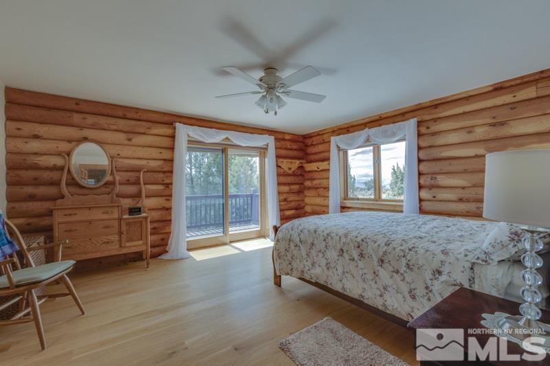 650 Curnow Canyon Road Reno, NV 89510 - Photo 23 of 40 a spacious bedroom with a bed a dresser and a large window