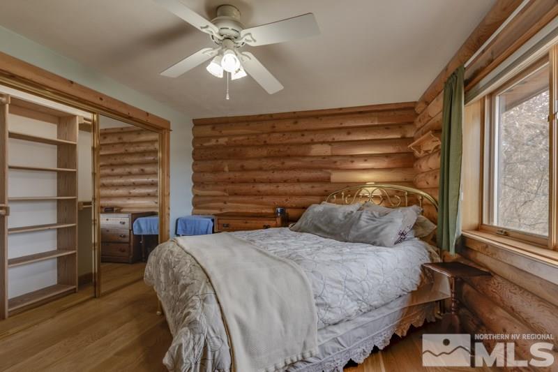 650 Curnow Canyon Road Reno, NV 89510 - Photo 32 of 40 a bedroom with a bed a chandelier and a window
