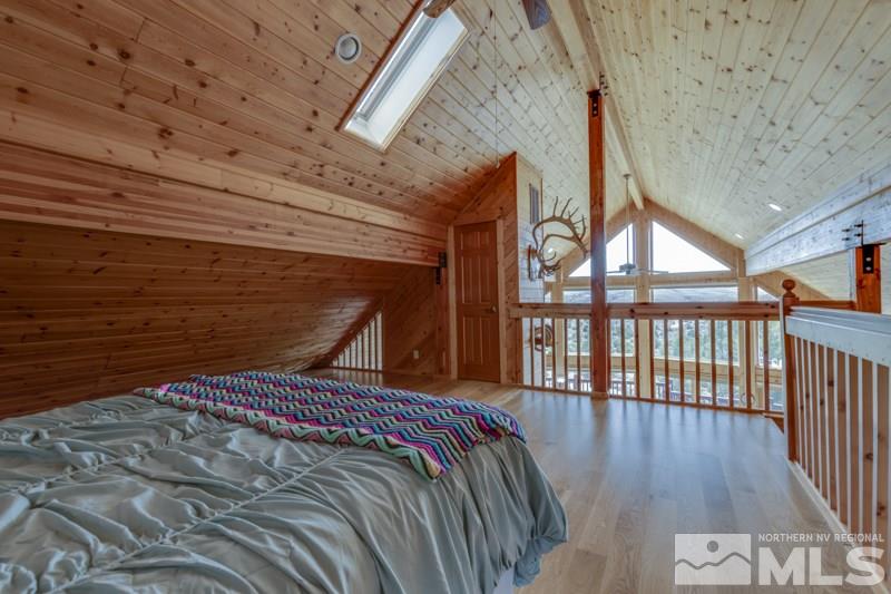 650 Curnow Canyon Road Reno, NV 89510 - Photo 33 of 40 a bed sitting in a bedroom next to a balcony