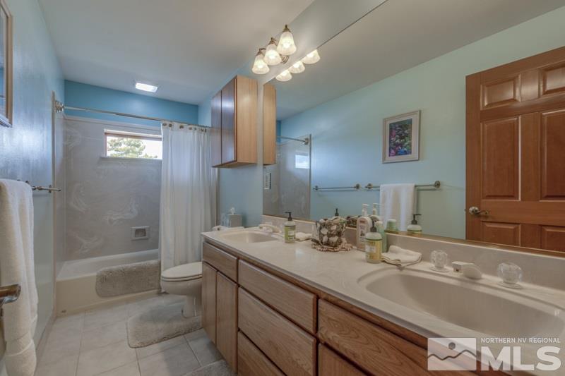 650 Curnow Canyon Road Reno, NV 89510 - Photo 34 of 40 a bathroom with a sink double vanity granite tub and shower