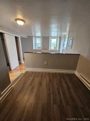 a view of room with window and wooden floor