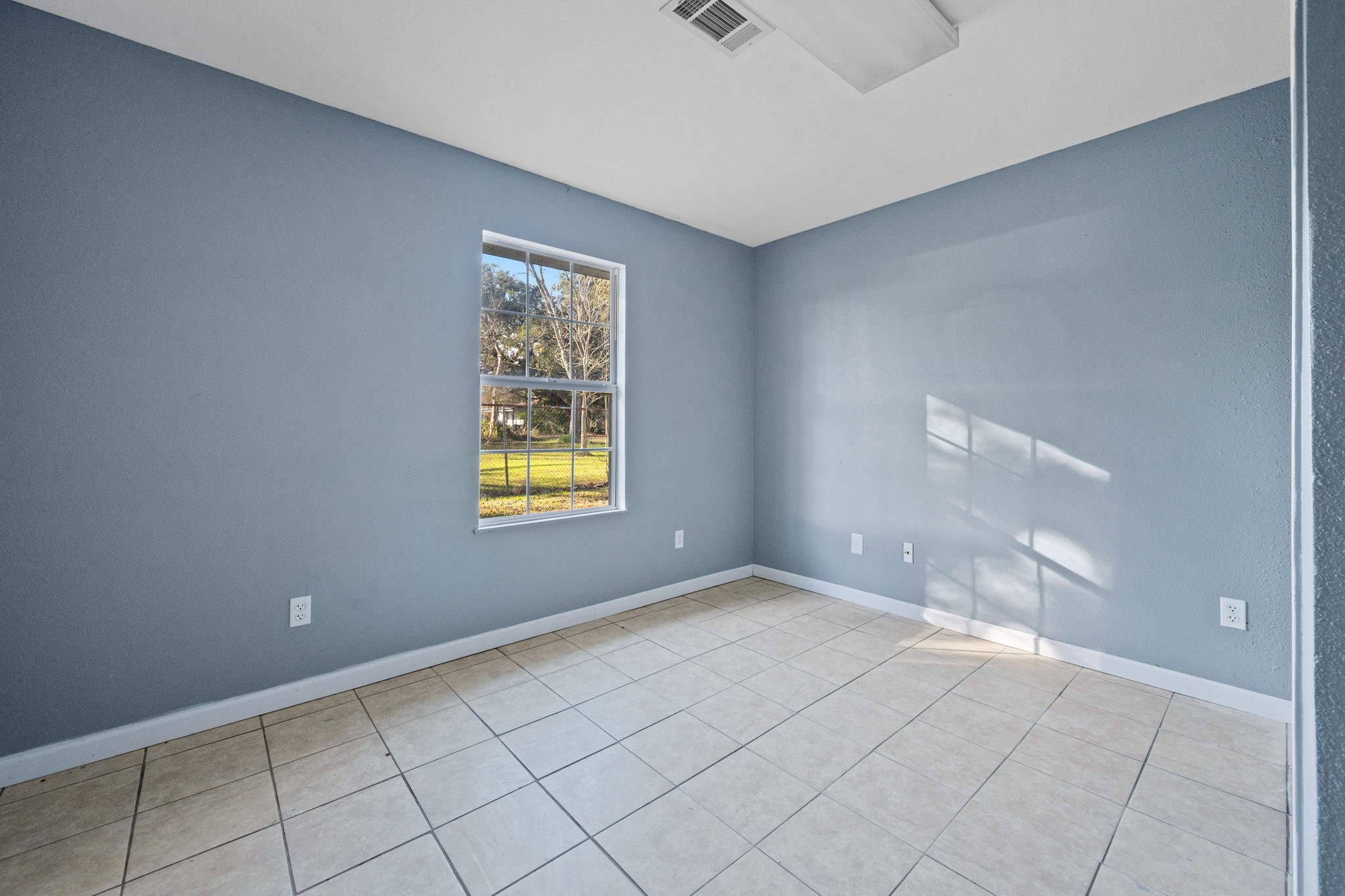 114 Main Street Hull, TX 77564 - Photo 11 of 25 a view of an empty room with window and chandelier fan