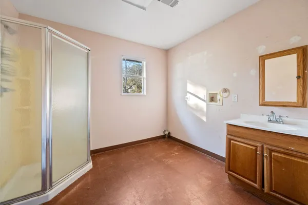 a bathroom with a sink a mirror and a window