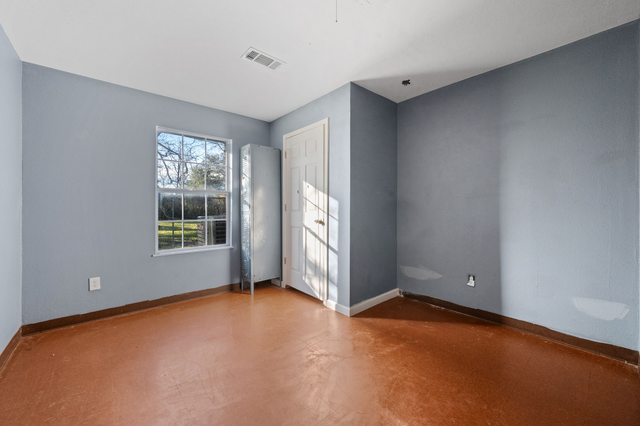 114 Main Street Hull, TX 77564 - Photo 13 of 25 an empty room with windows and closet