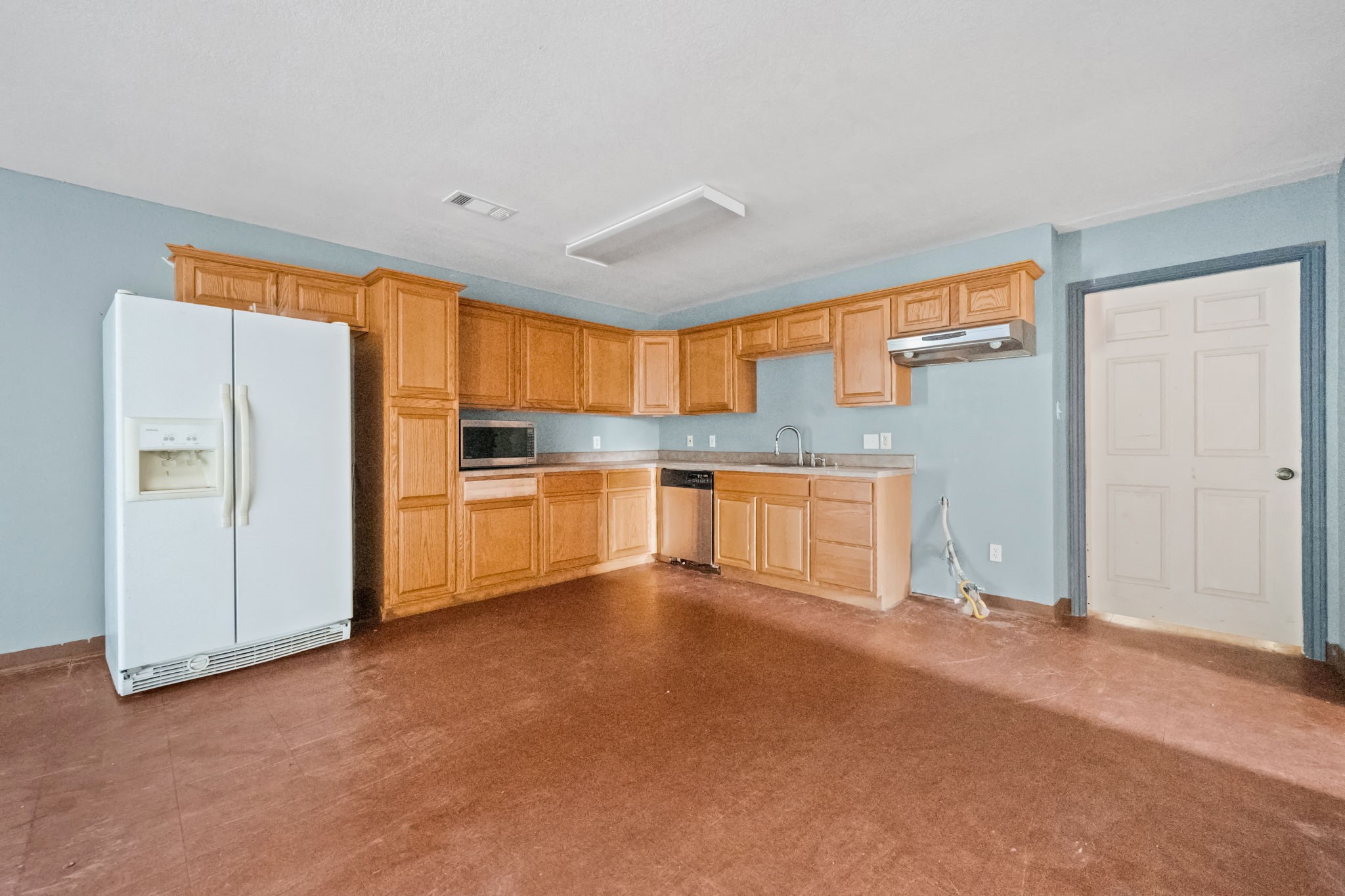 114 Main Street Hull, TX 77564 - Photo 9 of 25 a view of a kitchen with a refrigerator a sink and a dishwasher