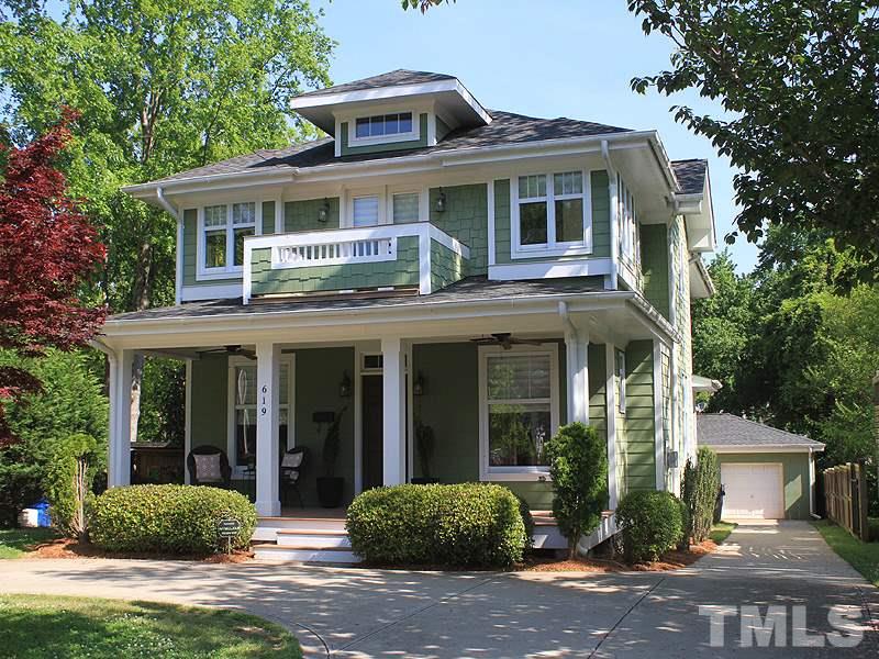 619 Mills Street Raleigh, NC 27608 - Photo 2 of 25 a view of a white house with large windows and a table and chairs next to a yard