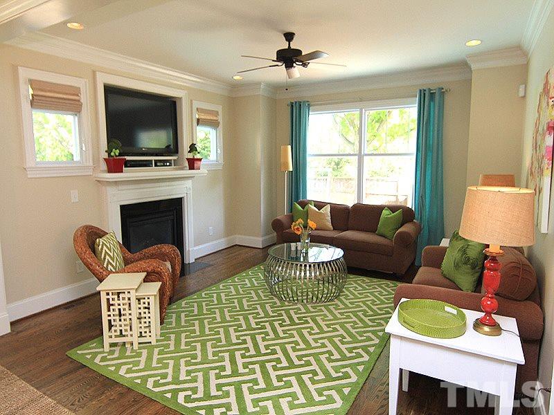 619 Mills Street Raleigh, NC 27608 - Photo 14 of 25 a living room with fireplace furniture and a flat screen tv