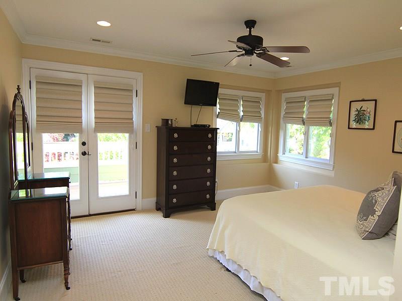 619 Mills Street Raleigh, NC 27608 - Photo 16 of 25 a bedroom with a bed and a television