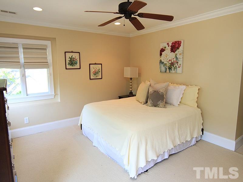 619 Mills Street Raleigh, NC 27608 - Photo 17 of 25 a bedroom with a large bed and a window