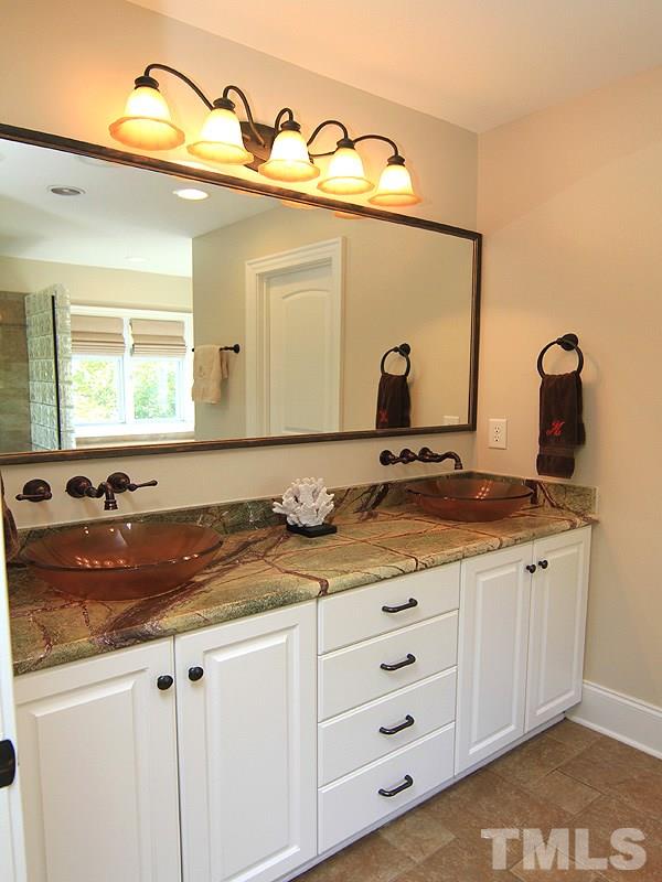 619 Mills Street Raleigh, NC 27608 - Photo 18 of 25 a bathroom with a granite countertop sink and a mirror