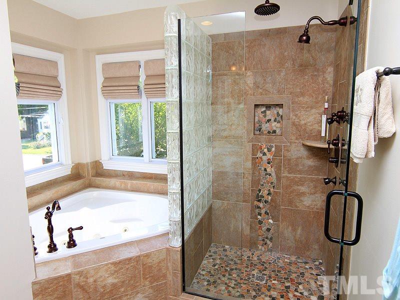 619 Mills Street Raleigh, NC 27608 - Photo 19 of 25 a bathroom with a bath tub with a shower