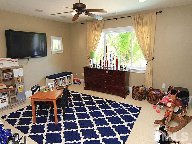 619 Mills Street Raleigh, NC 27608 - Photo 22 of 25 a bedroom with furniture and a flat screen tv