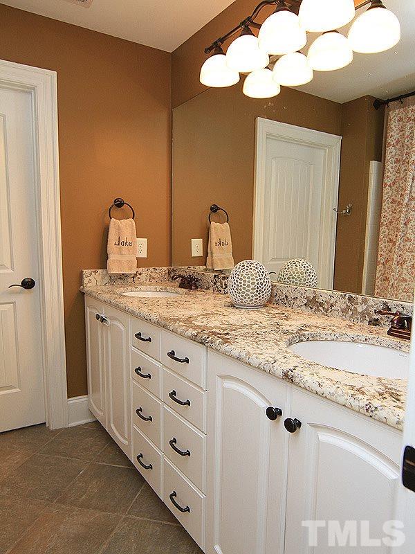 619 Mills Street Raleigh, NC 27608 - Photo 23 of 25 a bathroom with a granite countertop sink and a mirror