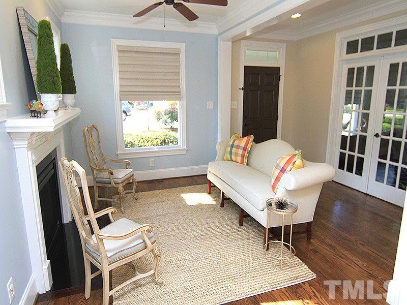 619 Mills Street Raleigh, NC 27608 - Photo 7 of 25 a living room with furniture a flat screen tv and a fireplace