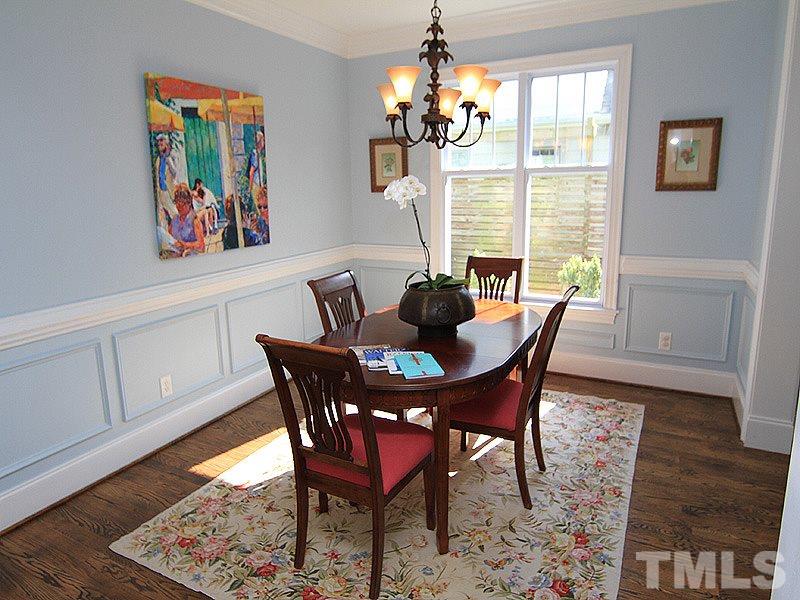 619 Mills Street Raleigh, NC 27608 - Photo 8 of 25 a view of a dining room with furniture wooden floor and chandelier