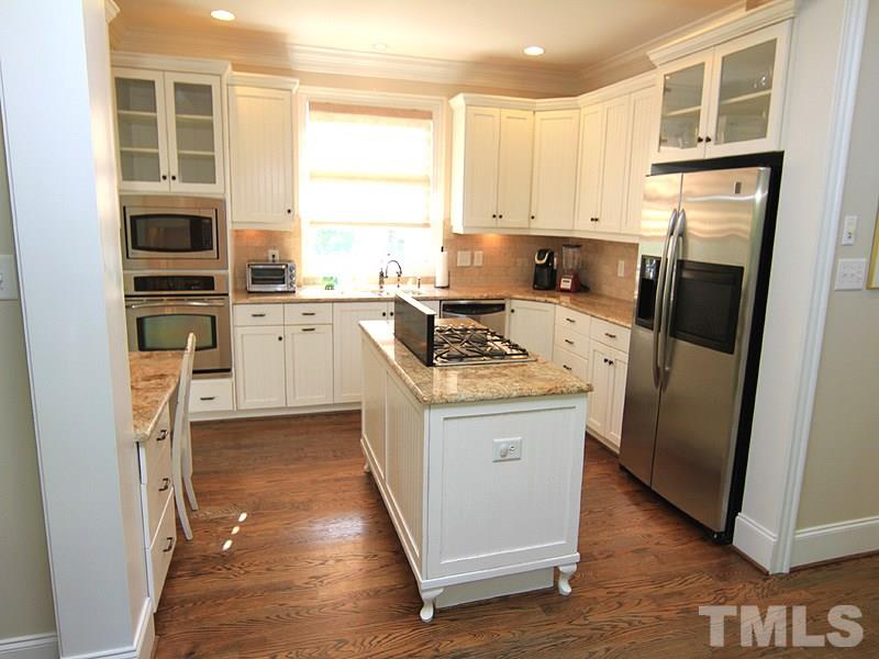 619 Mills Street Raleigh, NC 27608 - Photo 9 of 25 a kitchen with a refrigerator stove and sink