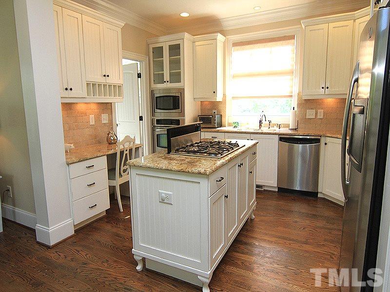 619 Mills Street Raleigh, NC 27608 - Photo 10 of 25 a kitchen with stainless steel appliances granite countertop a stove a sink and a refrigerator
