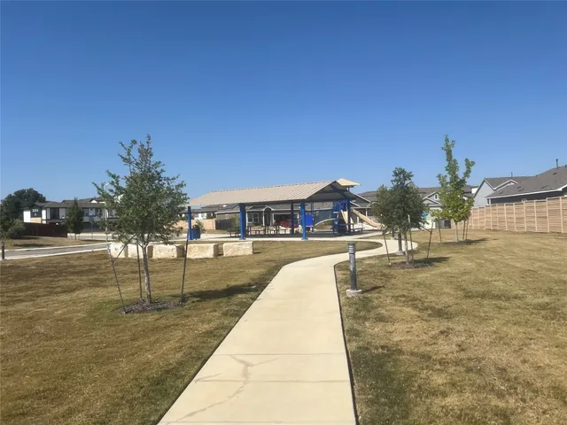 a swimming pool with outdoor seating and yard