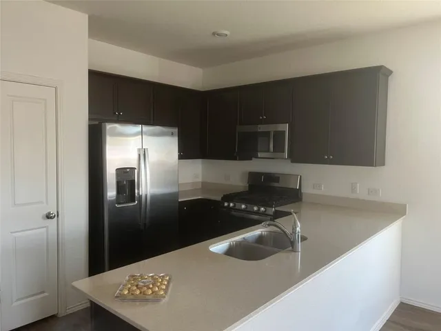 a kitchen with a refrigerator and a sink