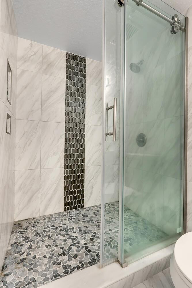 6882 West Sample Road, Unit 6882 Pompano Beach, FL 33063 - Photo 11 of 26 a bathroom with a shower and a toilet
