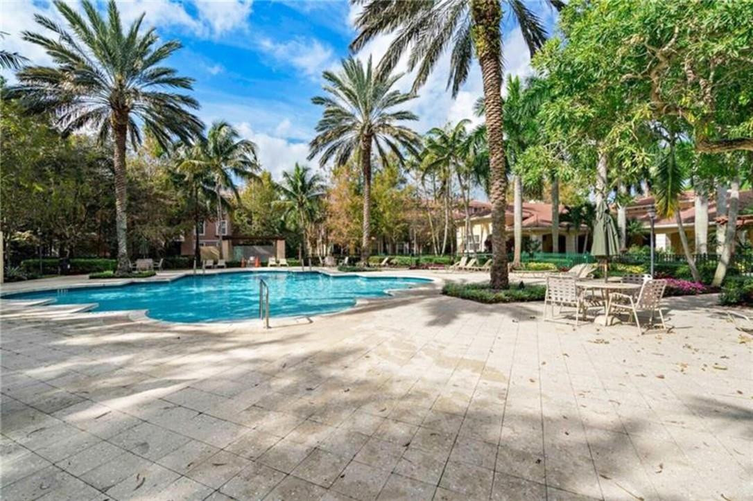 6882 West Sample Road, Unit 6882 Pompano Beach, FL 33063 - Photo 17 of 26 a view of a backyard with palm trees