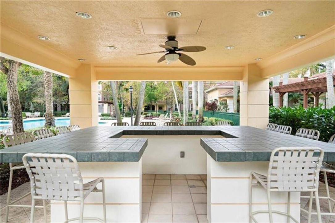 6882 West Sample Road, Unit 6882 Pompano Beach, FL 33063 - Photo 20 of 26 a dining table seating space with large windows