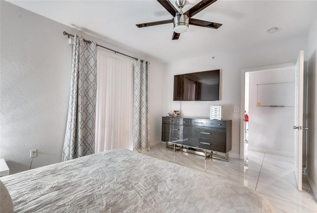 6882 West Sample Road, Unit 6882 Pompano Beach, FL 33063 - Photo 8 of 26 a view of a livingroom with furniture and a flat screen tv