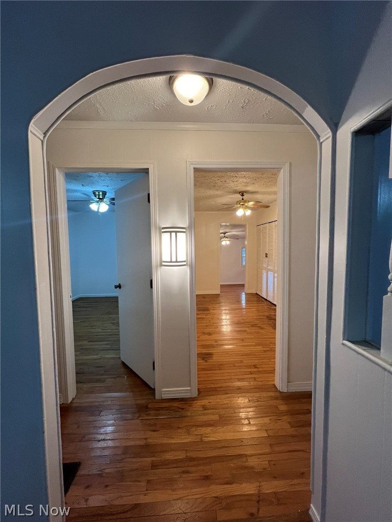 1105 Dutch Ridge Road Guysville, OH 45735 - Photo 8 of 33 Arched entryway featuring wood-finish flooring, flush mount lighting, and a wall sconce