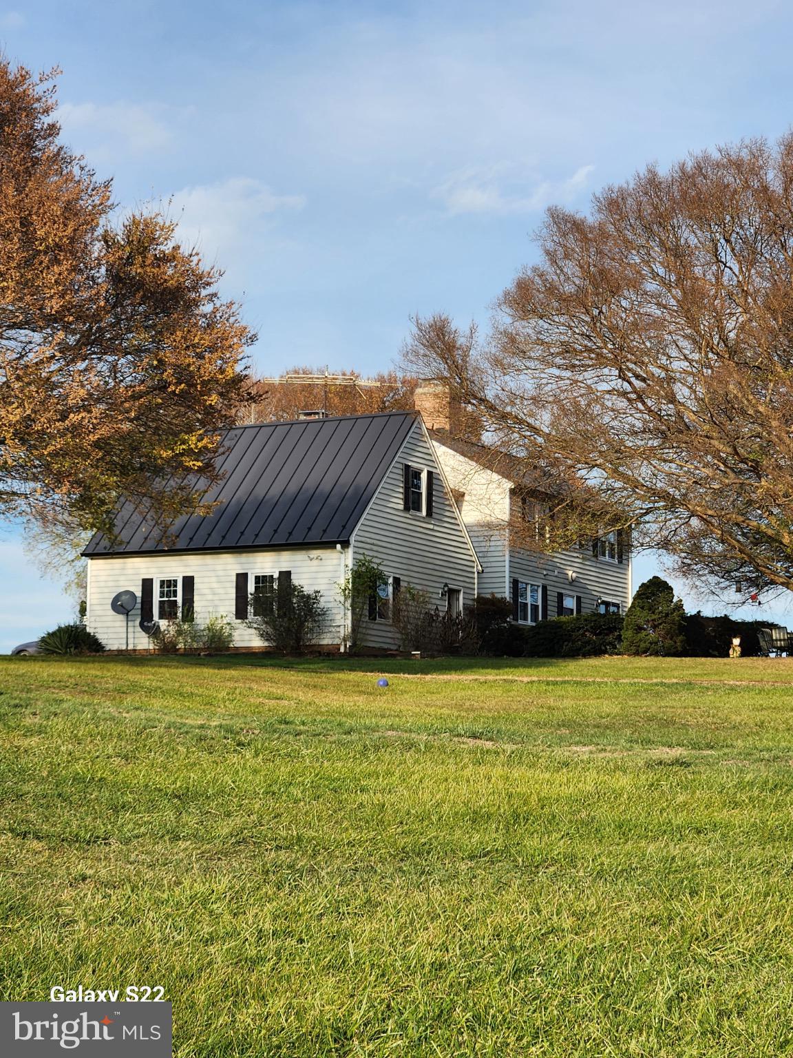 19255 Telegraph Springs Road Purcellville, VA 20132 - Photo 5 of 107 a view of a house with a big yard and large trees