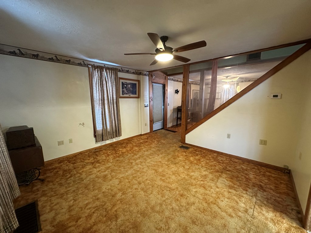 3776 Georgetown Road Polk, PA 16342 - Photo 20 of 26 a view of a livingroom with a ceiling fan and window
