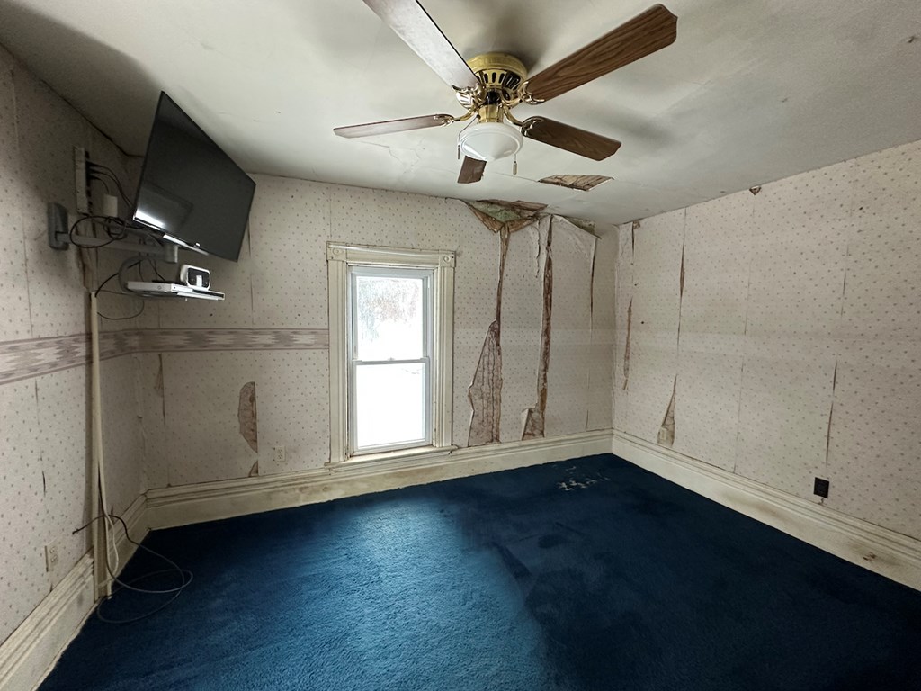 3776 Georgetown Road Polk, PA 16342 - Photo 24 of 26 an empty room with wooden floor fan and windows