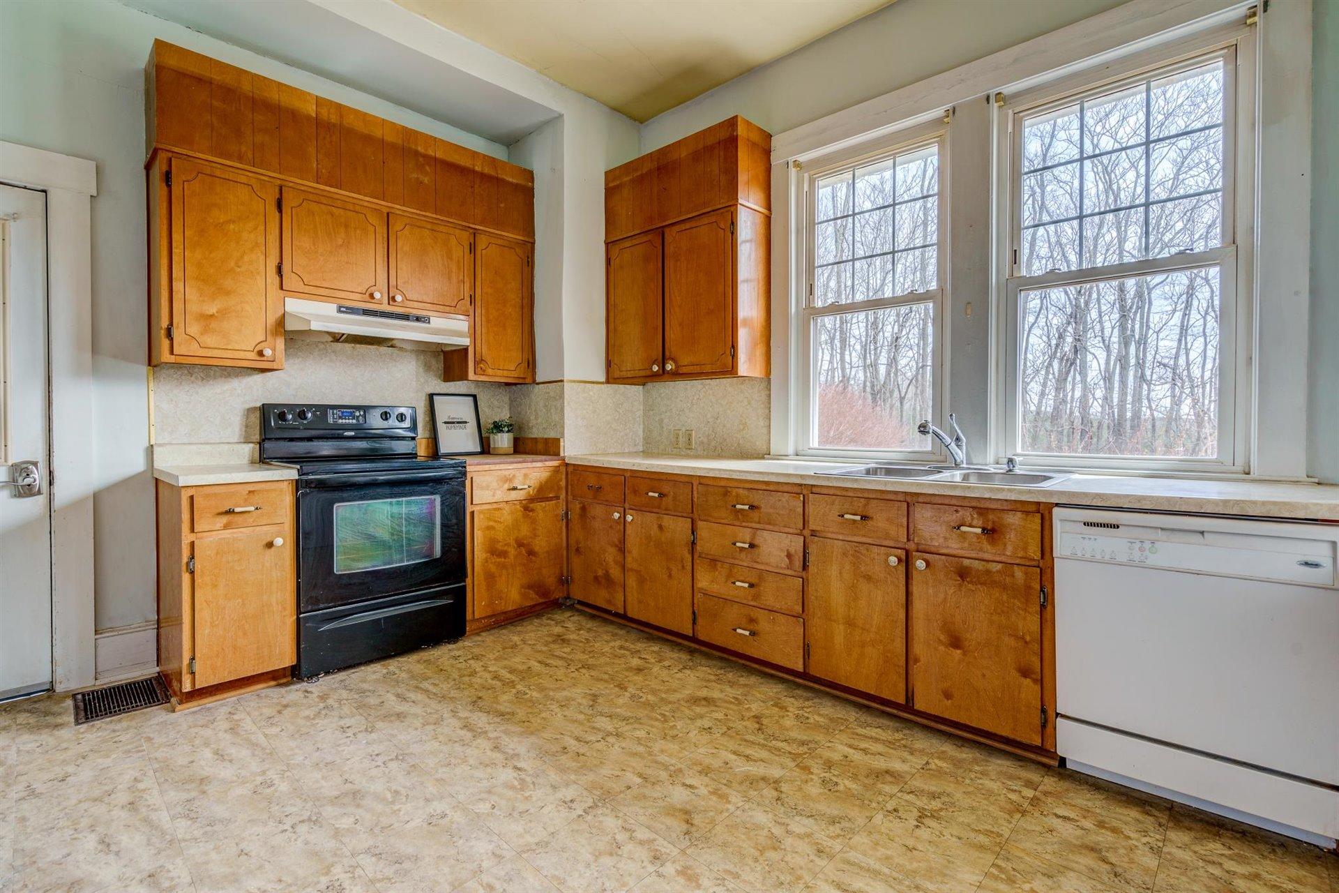 185 Tabernacle Road Penhook, VA 24137 - Photo 12 of 37 a kitchen with stainless steel appliances granite countertop a stove a sink and a microwave