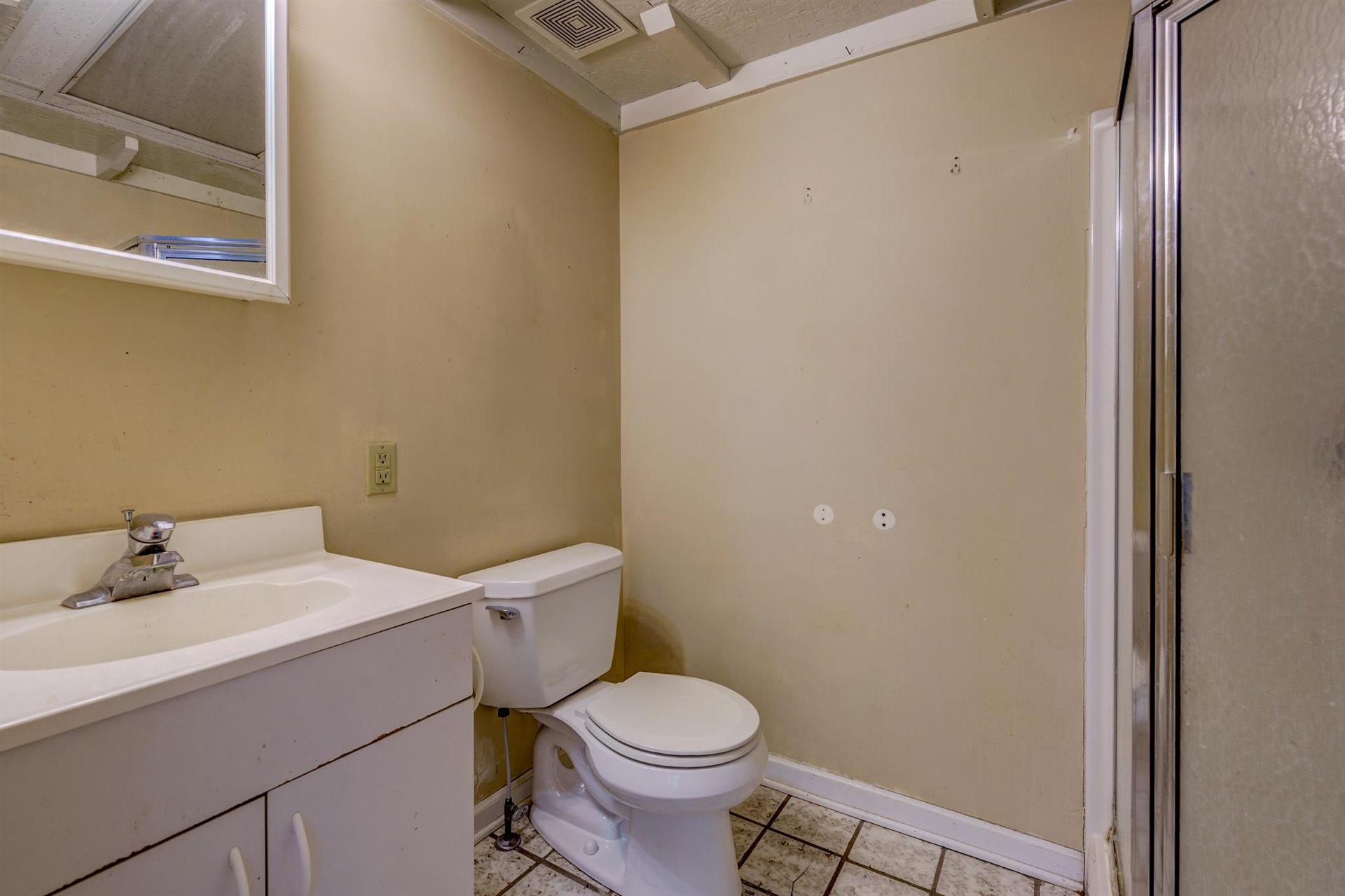 185 Tabernacle Road Penhook, VA 24137 - Photo 22 of 37 a bathroom with a sink a toilet and a mirror