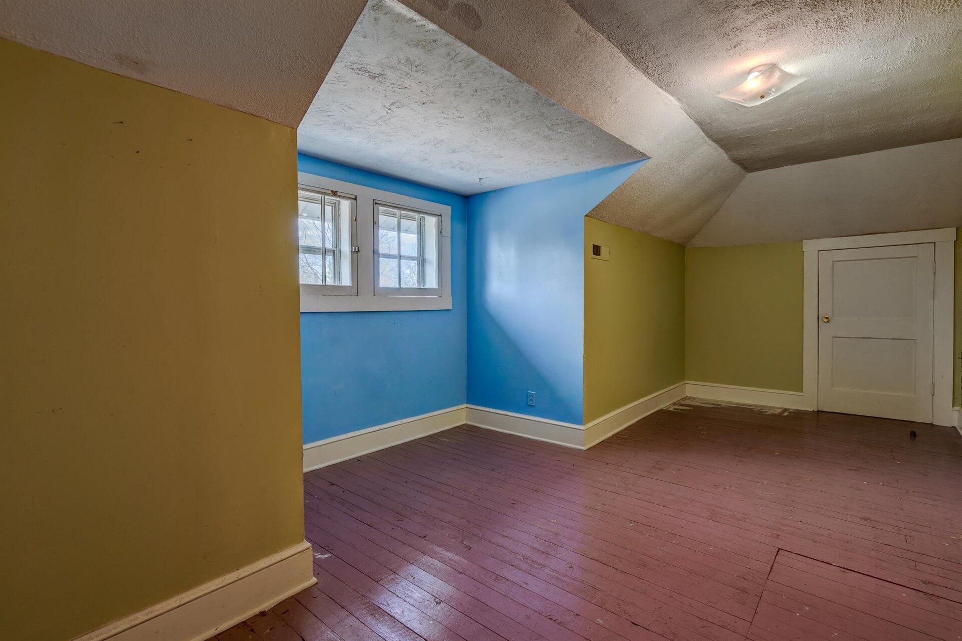 185 Tabernacle Road Penhook, VA 24137 - Photo 26 of 37 an empty room with wooden floor and windows