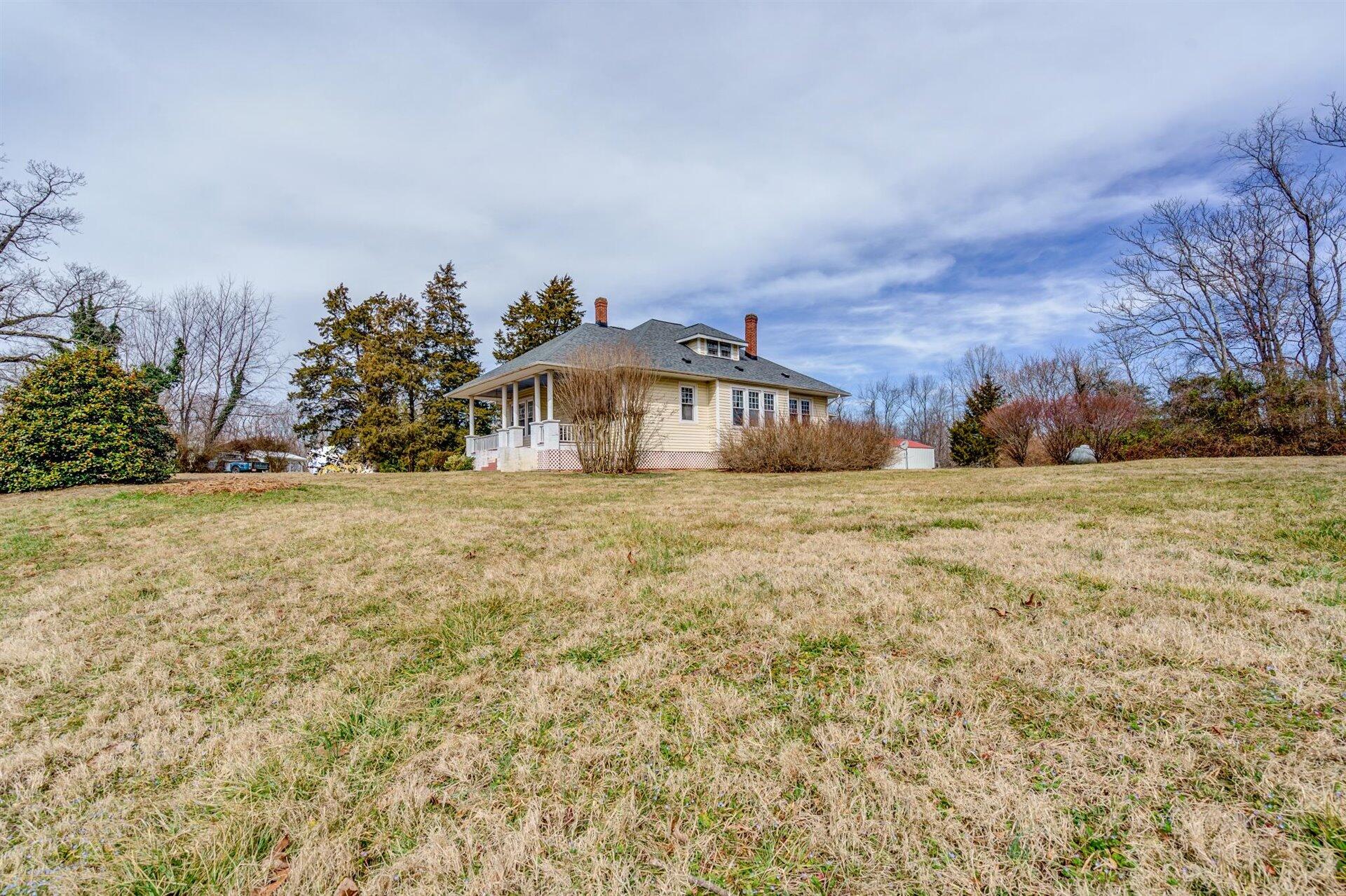 185 Tabernacle Road Penhook, VA 24137 - Photo 34 of 37 a view of house with yard and trees in the background