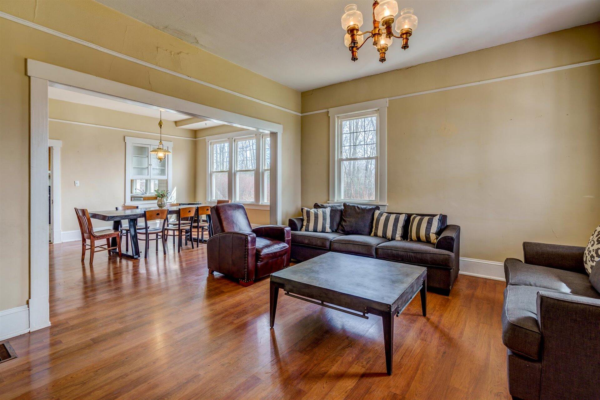 185 Tabernacle Road Penhook, VA 24137 - Photo 8 of 37 a living room with furniture dining table and a chandelier
