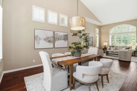 a view of a dining room with furniture a chandelier and wooden floor