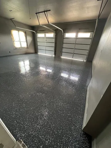 a view of a livingroom with wooden floor and a ceiling fan