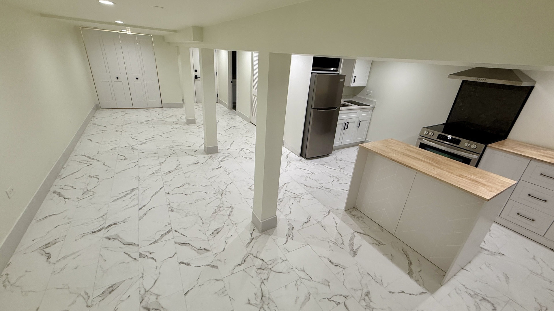 1906 West 34th Place, Unit G Chicago, IL 60608 - Photo 8 of 10 a view of a refrigerator in kitchen and empty room