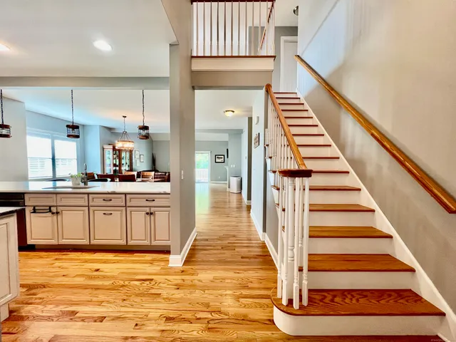 a view of kitchen with wooden floor and electronic appliances