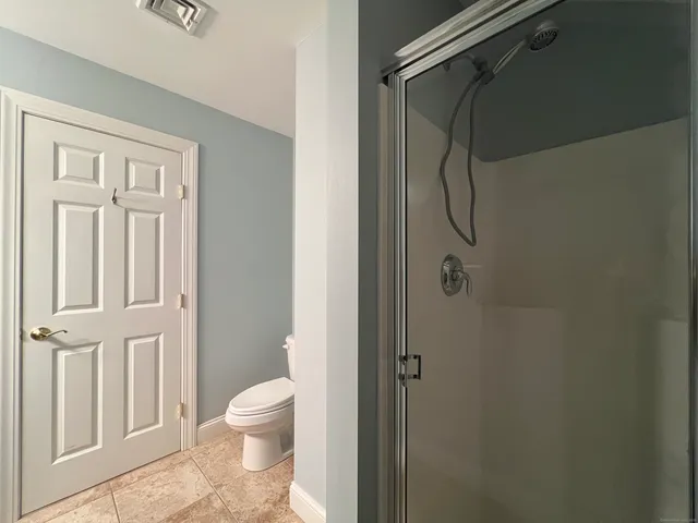 a bathroom with a shower and a toilet