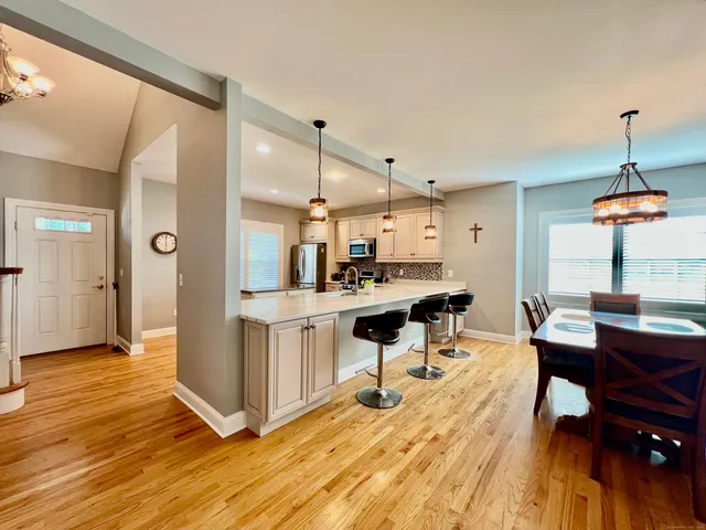 a view of kitchen with sink and wooden floor
