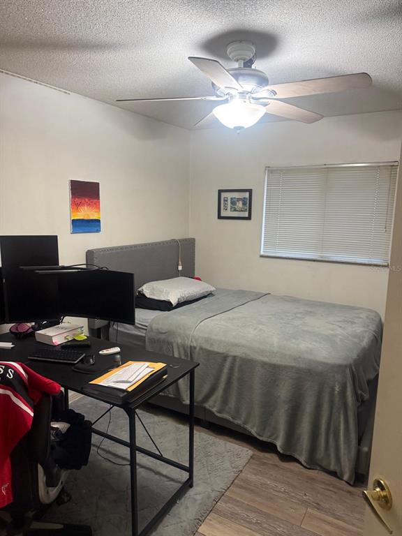 13055 Santee Street Spring Hill, FL 34609 - Photo 14 of 15 a bedroom with a bed and a table