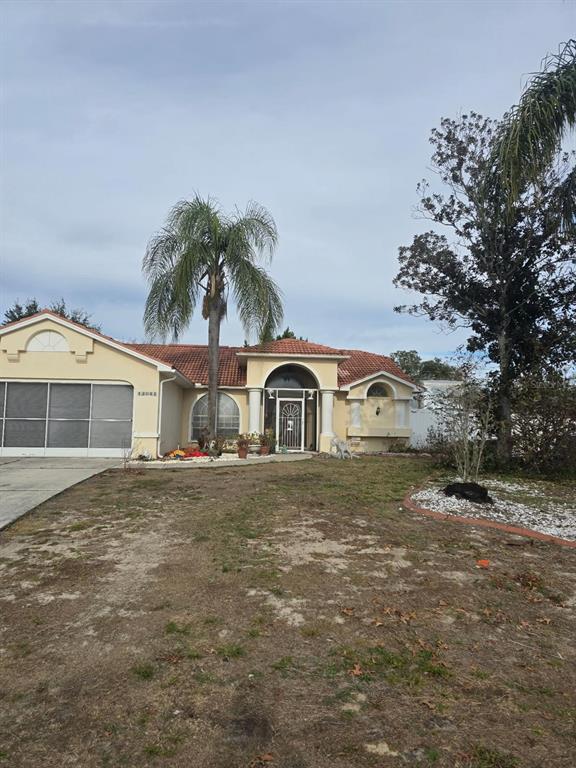 13055 Santee Street Spring Hill, FL 34609 - Photo 2 of 15 a front view of a house with a yard and garage