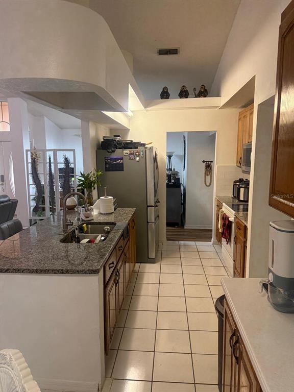 13055 Santee Street Spring Hill, FL 34609 - Photo 6 of 15 a kitchen with refrigerator and stove