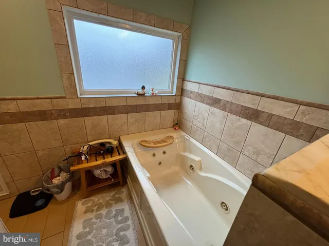 a bathroom with a bathtub and sink
