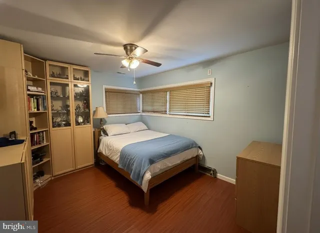 a spacious bedroom with a bed and a chandelier
