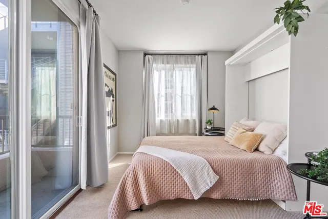 a bedroom with a bed and a potted plant