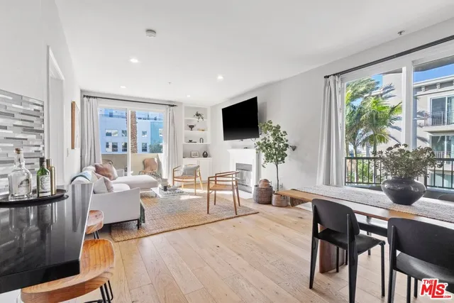 a living room with furniture a large window and a flat screen tv